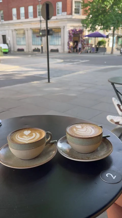 Two Latte Art Coffee Cups On Cafe Terrace With London Street Background Stock Footage 335903663