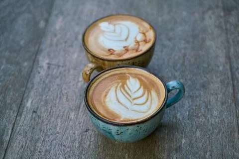 Two latte coffees on the table Stock Photos