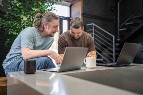 Two laughing It Software engineers working on project and programming in coffee Foto stock