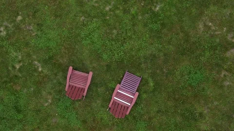 Two lawn chairs in front of house (flying above pair sitting seat deck chair) Stock-Footage 278274529
