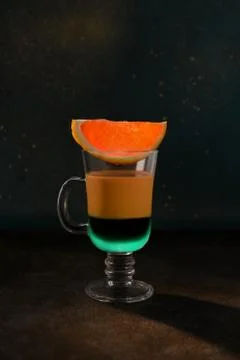 Two-layer coffee cocktail with mint and red orange. Stock Photos
