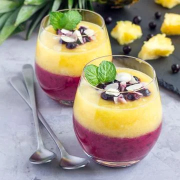 Two layer smoothie with black currant, quick oats, yogurt and pineapple, bana 스톡 사진
