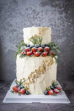 Two layer Wedding cake with strawberries and blueberries Stock Photos