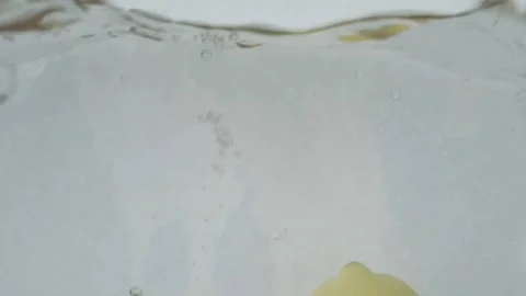 Two lemon halfs falling in clear fresh water. Stock Footage 146947507