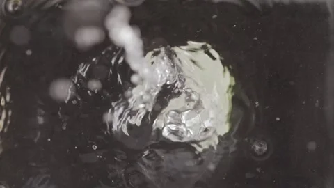Two lemon halfs falling in clear fresh water. Stock Footage 146947862