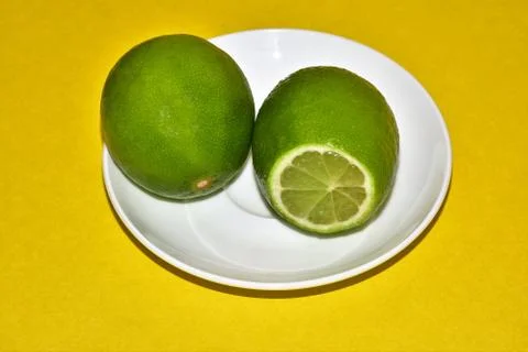 Two lemons on a saucer Stock Photos