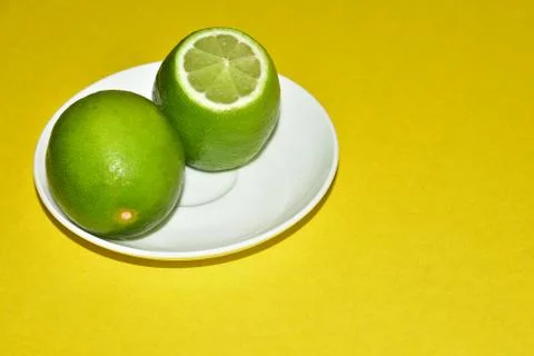 Two lemons on a saucer Stock Photos