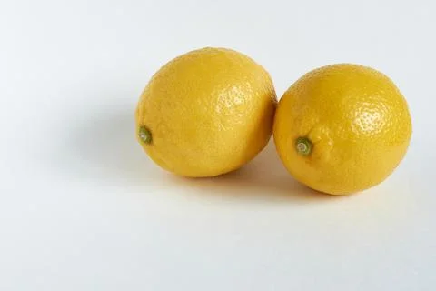 Two lemons on a white background with space for your text. Stock Photos
