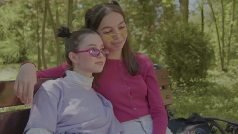 Two lesbian chicks spend time hugging and when someone walks they push each Vídeo Stock 201699137