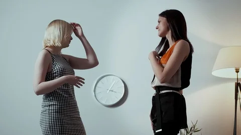 Two lesbians are talking in a bright spacious room, two cute friends are Stock Footage 99147936