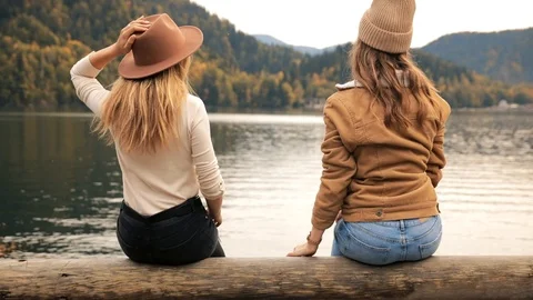 Two lesbians hold hands attractive girls young women fashionably dressed on Stock Footage 121156736