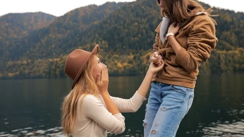 Two lesbians make an offer to get married and agree, attractive young women Stock Footage 121156681