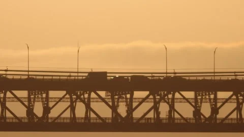 A two-level bridge for electric trains and cars at sunset Stock Footage 255042557
