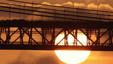 A two-level bridge for electric trains and cars at sunset - a huge bright sun Stock Footage 255042693