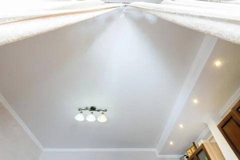 Two-level ceiling with a small chandelier in the interior of the room Stock Photos