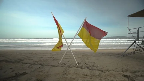 Two lifeguard flags on a beach Stock Footage 89774460