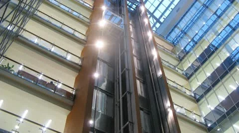 Two lifts move downwards and upwards  in business center Stock Footage 10808246