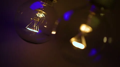 Two light bulbs in the dark light up and go out. Tesla light bulb. Stock Footage 223920487