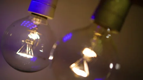 Two light bulbs in the dark light up and go out. Tesla light bulb. Stock Footage 223921186