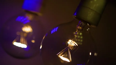 Two light bulbs in the dark light up and go out. Tesla light bulb. Stock Footage 223921341