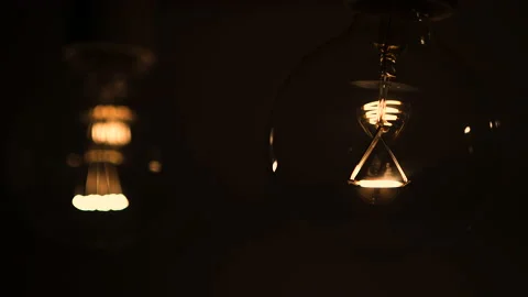 Two light bulbs in the dark light up and go out. Tesla light bulb. Stock Footage 223921448