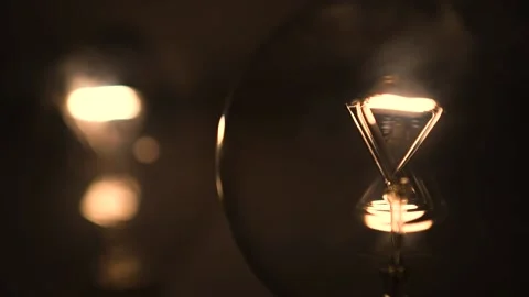 Two light bulbs in the dark light up and go out. Tesla light bulb. Stock Footage 223921467