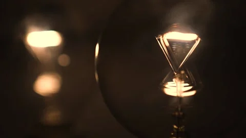 Two light bulbs in the dark light up. Tungsten light bulb lamp turn on slowly Stock Footage 223921512