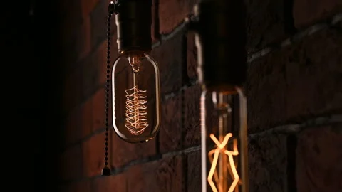 Two light bulbs hanging on the wall. Power outages. Flickering lamps. Edison 스톡 동영상 300893001