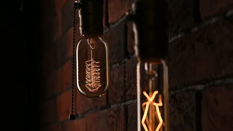 Two light bulbs hanging on the wall. Power outages. Flickering lamps. Edison 動画素材 300897701
