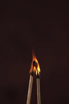 Two lighted matches on a dark background Foto stock