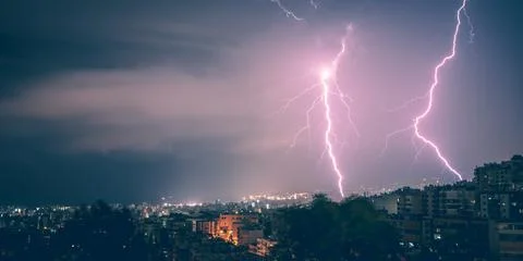 Two lightning in the city at night Stock Photos
