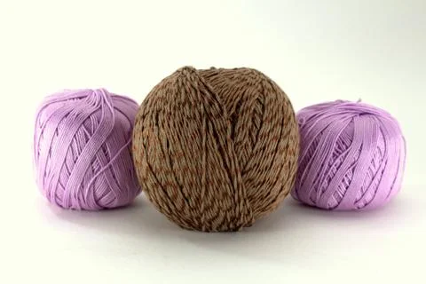 Two lilac tangle and one brown tangle of natural cotton for needlework Stock Photos