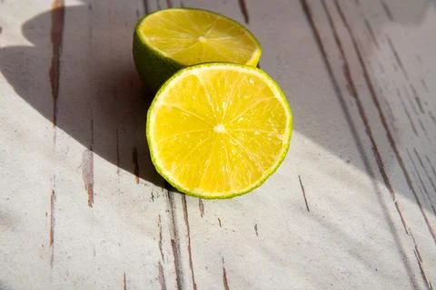 Two lime halves close-up, copy space, pattern, rough shadows 스톡 사진
