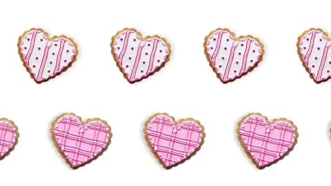 Two lines with Heart shape ginger breads decorated with pink and white sugar Stock Footage 168328060