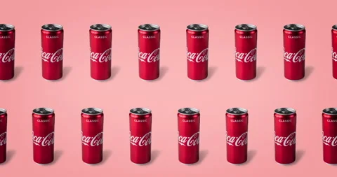 Two lines of tin coca cola cans animated on a pink backgroun Stock Footage 135733270