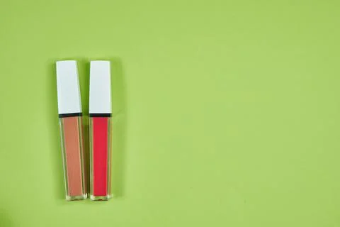 Two lipstick pink brown pattern on green background isolation Stock Photos