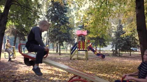 Two little boy on a swing ride. Woman training on the simulator. Stock Footage 68400565