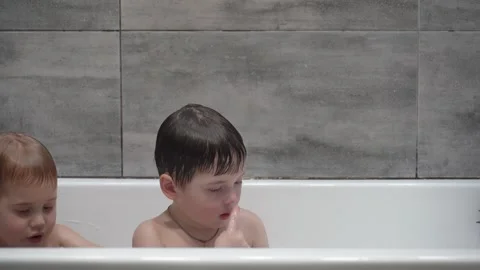Two little boys having fun while taking bath in bathtub. Stock-Footage 331253612