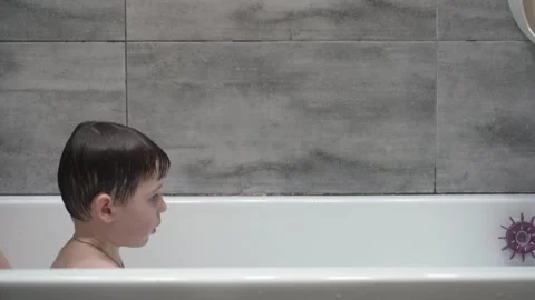 Two little boys having fun while taking bath in bathtub. Stock Footage 331253683