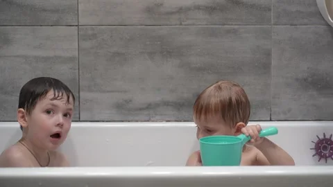 Two little boys having fun while taking bath in bathtub. Stock Footage 331253716