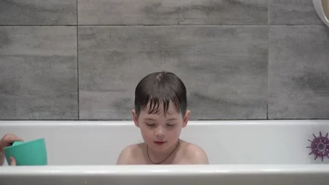 Two little boys having fun while taking bath in bathtub. Stock Footage 331253717