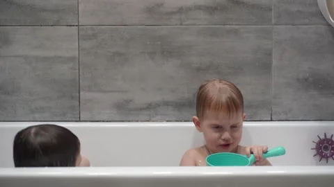Two little boys having fun while taking bath in bathtub. Stock Footage 331253726