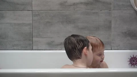 Two little boys having fun while taking bath in bathtub. Stock Footage 331253811