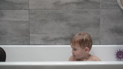 Two little boys having fun while taking bath in bathtub. Stock Footage 331253816