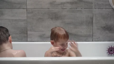 Two little boys having fun while taking bath in bathtub. Stockbeeldmateriaal 331253843