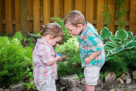 Two little boys looking at an easter egg Stock Photos