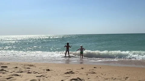Two little boys playing on beach on summer holidays. Joyful children near sea Stock Footage 259465535