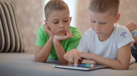 Two little boys playing on the tablet computer games Stock Footage 40331629