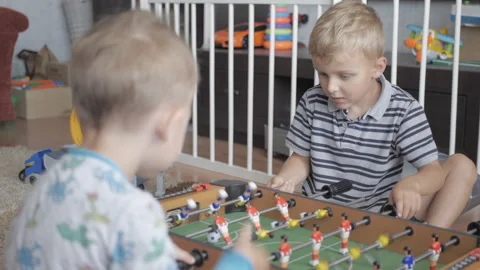 Two little brothers playing table football at home Video stock 158636814