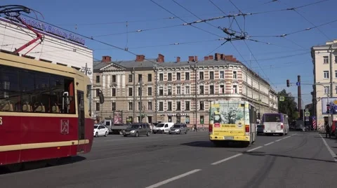 Two little buses and refurbished retro-style tram pass along Finland Railway Stn Stock Footage 67468152